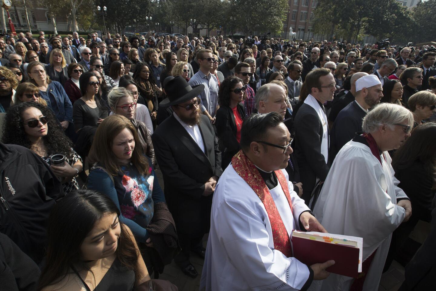 Hundreds of mourners listen to a speaker during a remembrance ceremony honoring slain USCprofessor Bosco Tjan.