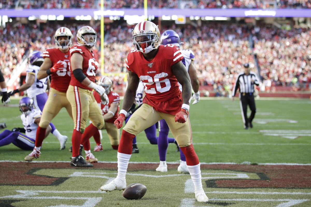 Tevin Coleman (26) celebrates after scoring a touchdown against the Vikings during the first half of an NFL divisional playoff game Jan. 11 at Levi's Stadium.