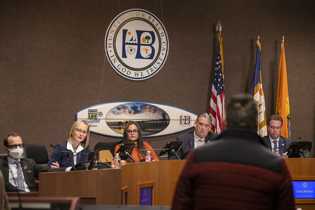 Members of the Huntington Beach City Council listen to Alex Mohajer during a meeting on Tuesday.