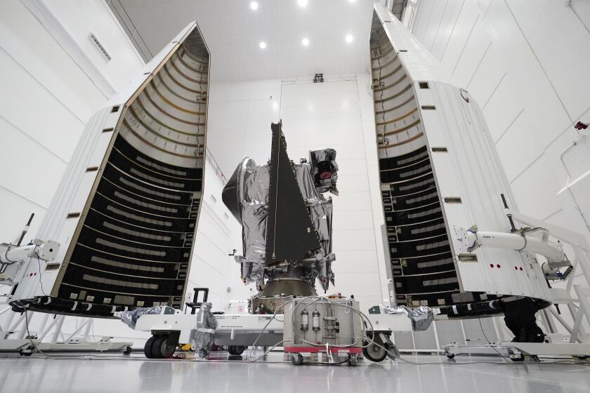 NASA's Lucy spacecraft, along with its housing, awaits its launch at the AstroTech facility in Titusville, Fla. 