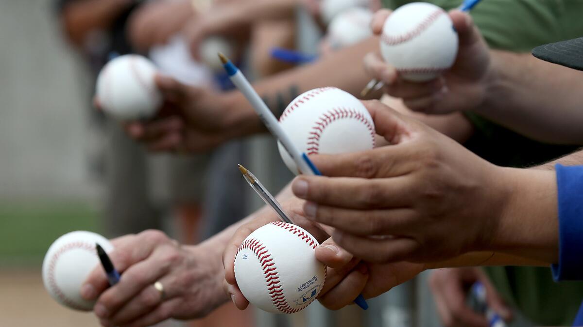 Fans wait for player autographs at the Dodgers spring training practice facility in Phoenix in February.