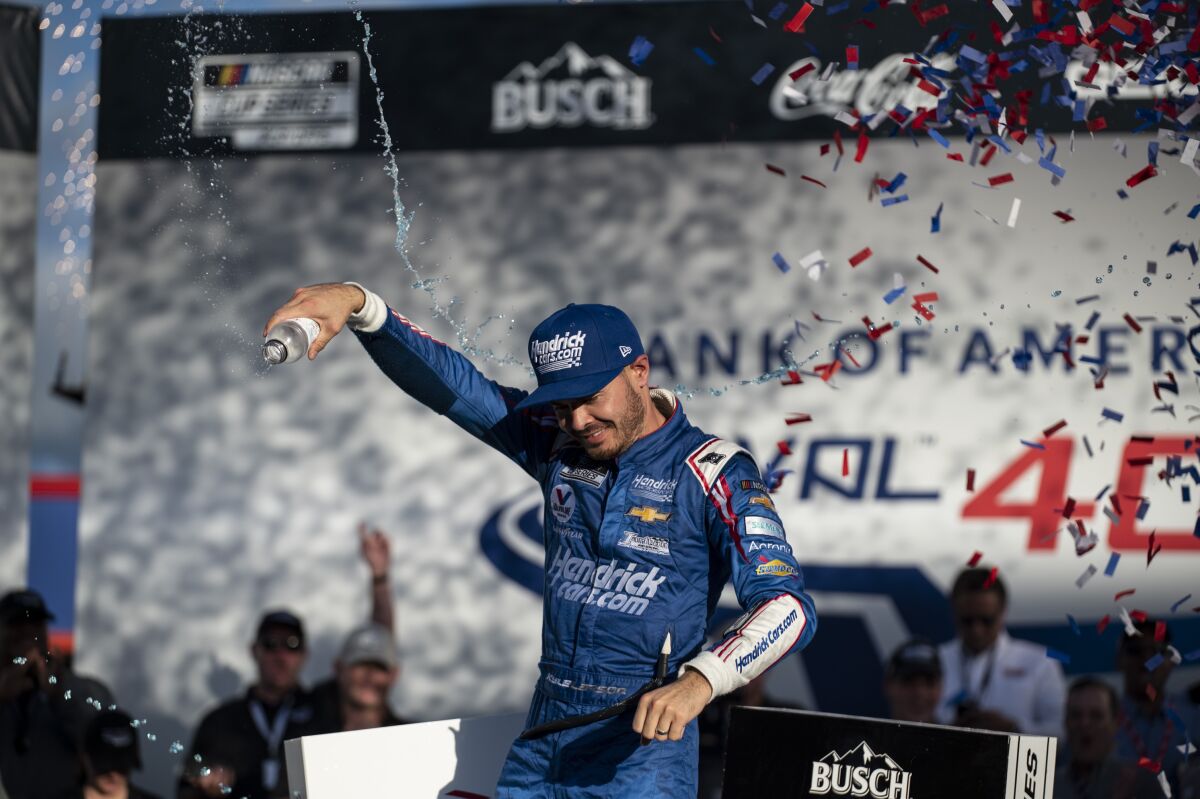 Kyle Larson celebrates in Victory Lane after winning a NASCAR Cup Series auto racing race at Charlotte Motor Speedway, Sunday, Oct. 10, 2021, in Concord, N.C. (AP Photo/Matt Kelley)