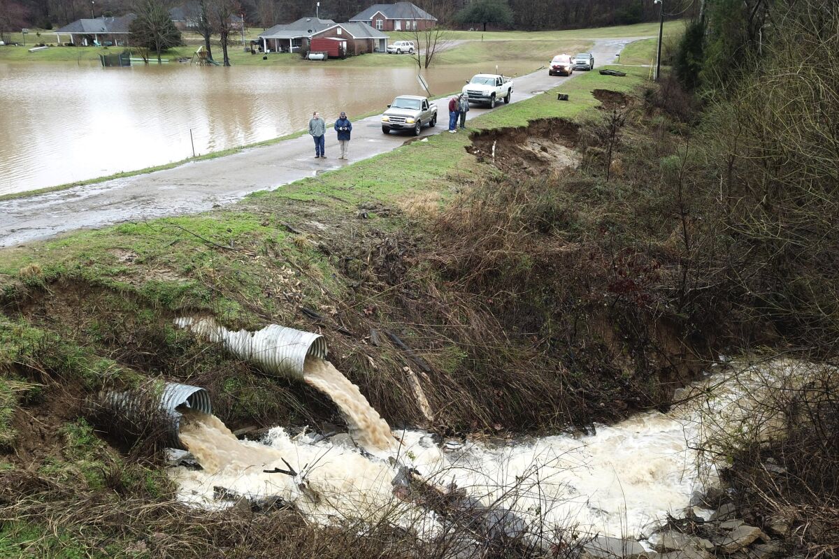 FILE - In this aerial photo provided by the Mississippi Emergency Management Agency, area officials monitor a potential dam/levee failure in the Springridge Place subdivision in Yazoo County, Miss., Tuesday, Feb. 11, 2020. Federal money is poised to flow to states to address a pent-up need to repair, improve or remove thousands of aging dams across the U.S., including some that could devastate downstream towns or neighborhoods. The money is included in a $1 trillion infrastructure bill signed by President Joe Biden and is significantly more than has gone to dams in the past. (David Battaly/Mississippi Emergency Management Agency via AP, File)
