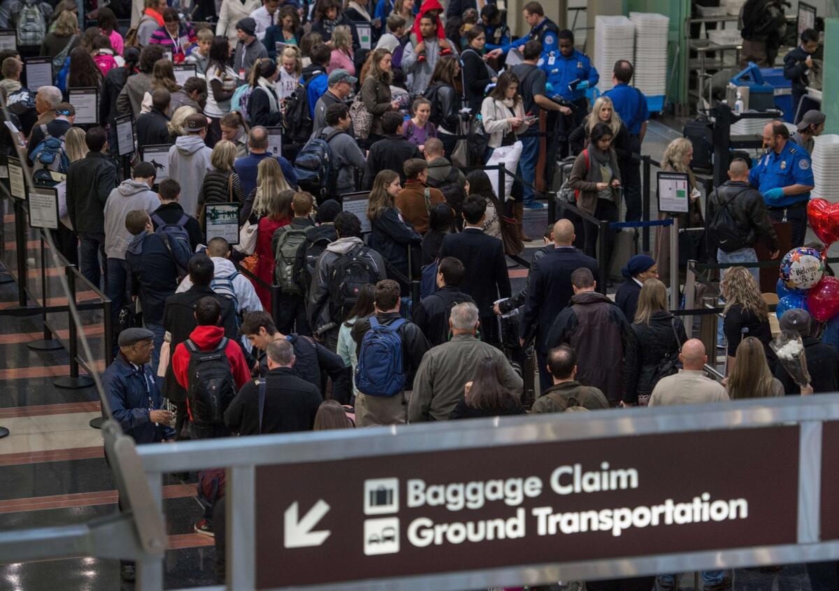Holiday travelers line up for one of the TSA security checkpoints at Ronald Reagan National Airport in Washington.
