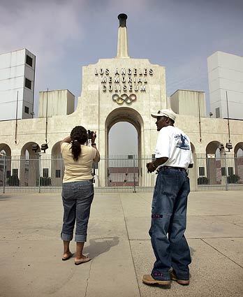 South Carolina native Julia Hooker (left) shoots video as her friend Ernest Strickland brings her to see the famous Los Angeles Coliseum.