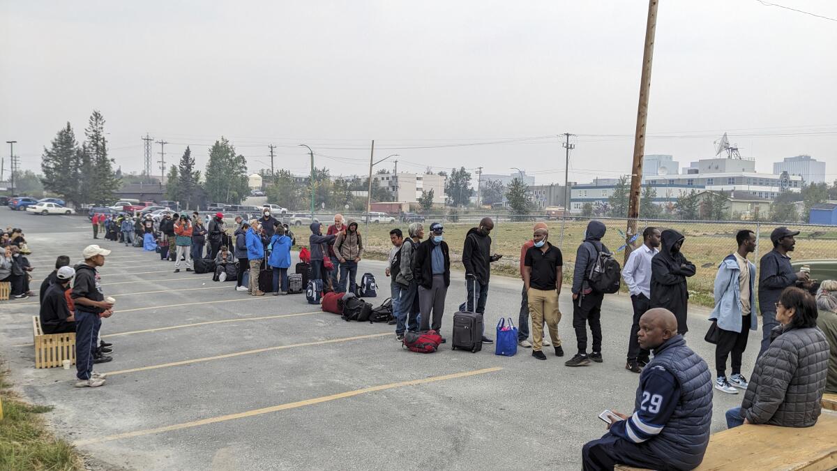 People without vehicles line up to register for a flight in Yellowknife, Canada.