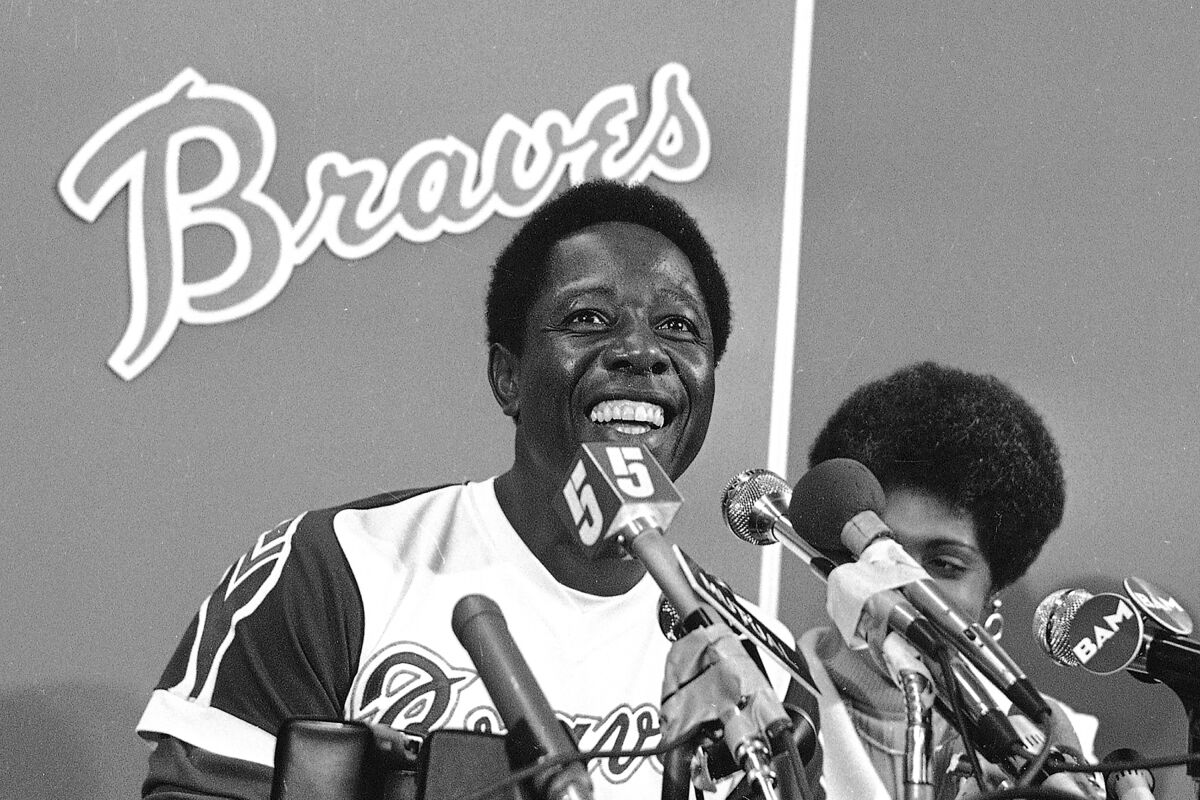 Atlanta Braves' Hank Aaron sits next to his wife, Billye, after the game in which he hit his 715th home run.
