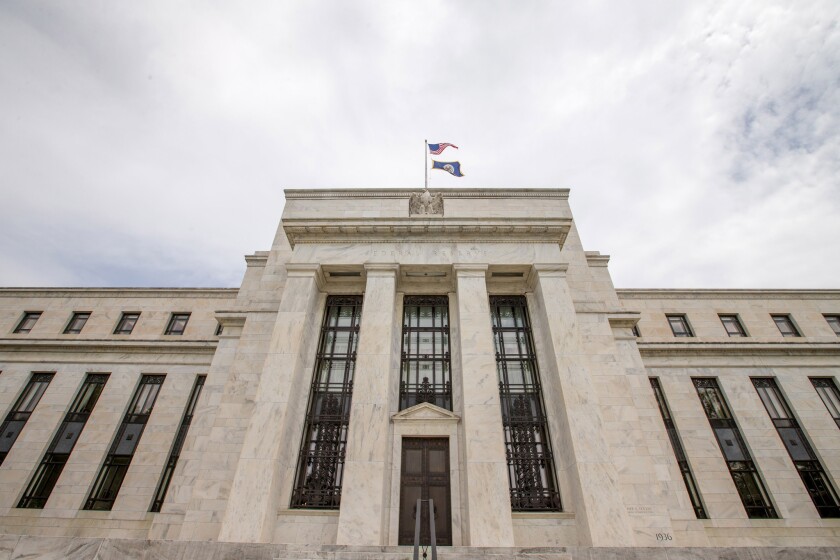 The Marriner S. Eccles Federal Reserve Board Building in Washington. Federal Reserve policymakers on Wednesday held a key interest rate steady and signaled there would be no more than two small hikes this year.