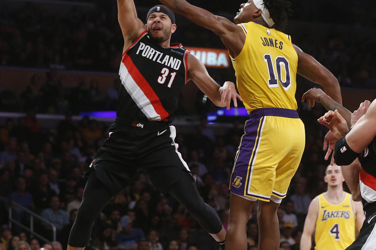 Lakers forward Jemerrio Jones (10) blocks a shot attempt by Portland Trail Blazers guard Seth Curry.