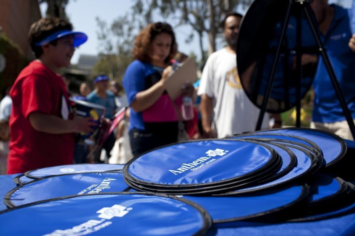 Anthem Blue Cross has grabbed the biggest share of California health insurance exchange enrollment through December. Above, the company promotes its health plans at a Los Angeles event.