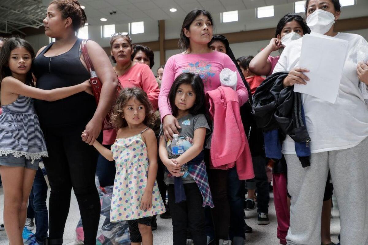Immigrant families line up to be processed at Central Station after being released from federal custody.