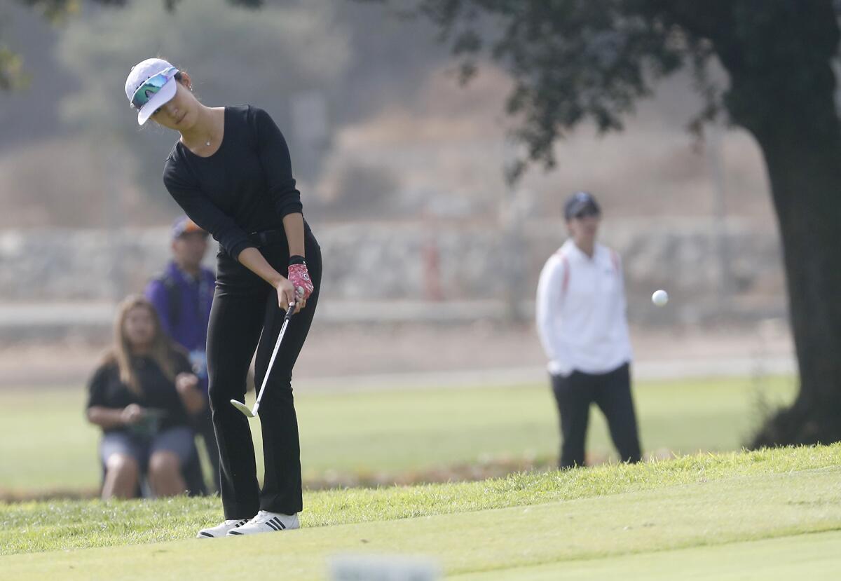 Newport Harbor's Wa Yeung Tong chips a shot toward the second hole in the CIF Southern California Regional championships at Brookside Golf & Country Club in Pasadena on Thursday.