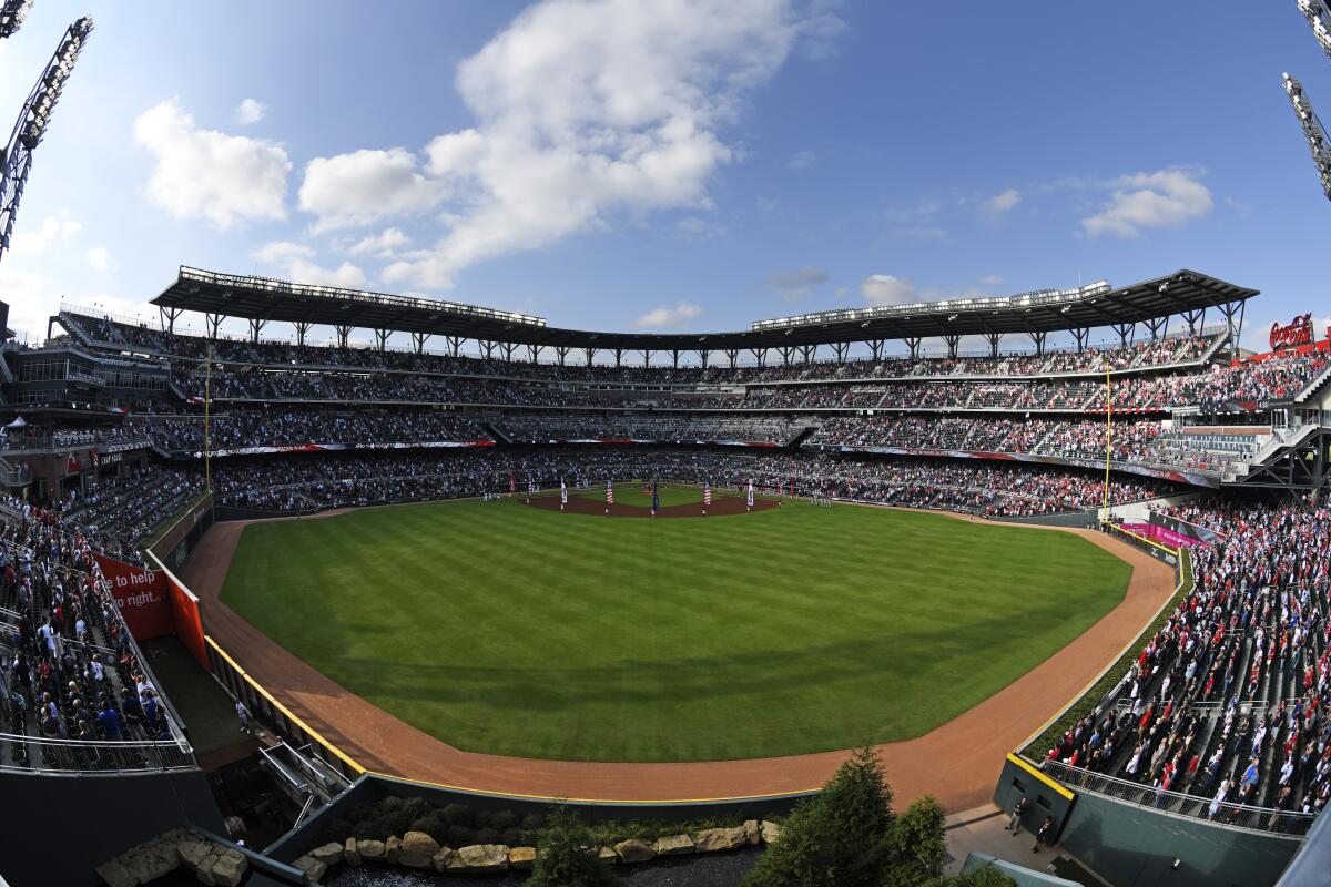 Fans stand for the National Anthem before Game 5 of the NLDS between the Atlanta Braves and the St. Louis Cardinals on Wednesday in Atlanta.