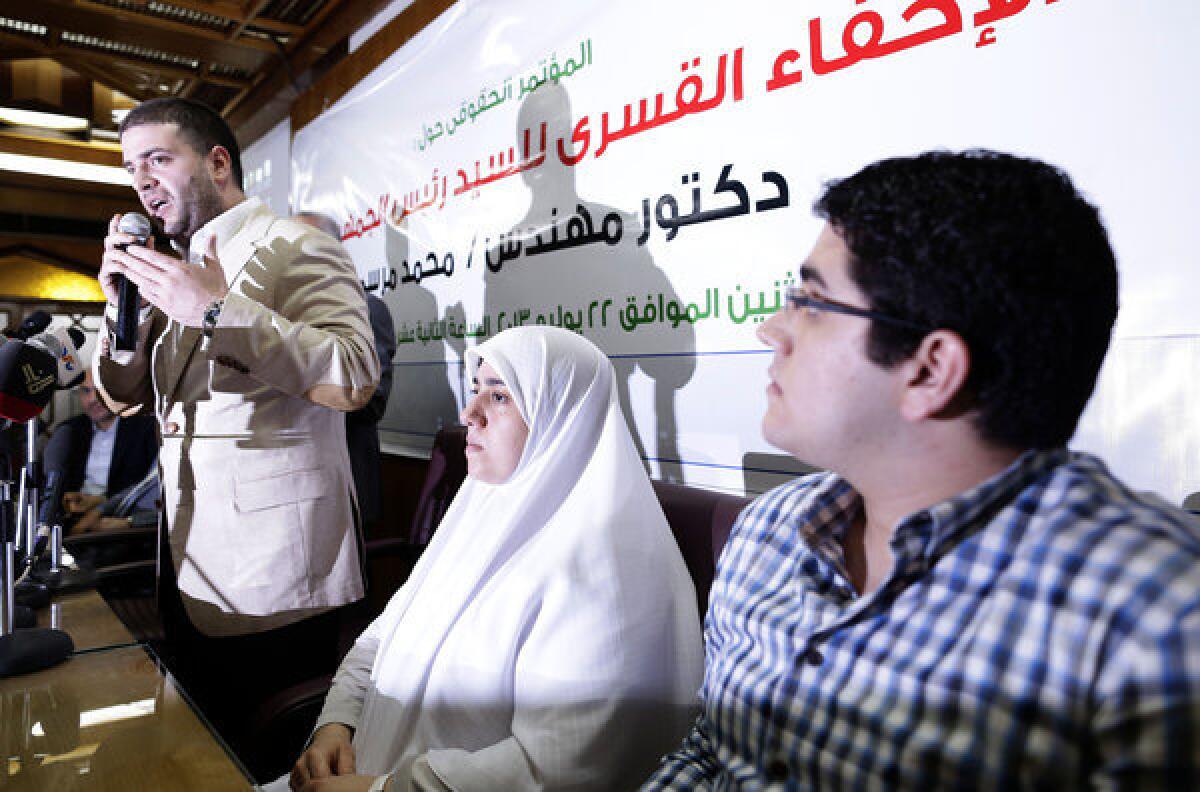 The children of ousted Egyptian President Mohamed Morsi -- Osama Morsi (left), Shaimaa, and Abdullah -- hold a news conference in Cairo on Monday. They threatened legal action against the Egyptian military for detaining their father.