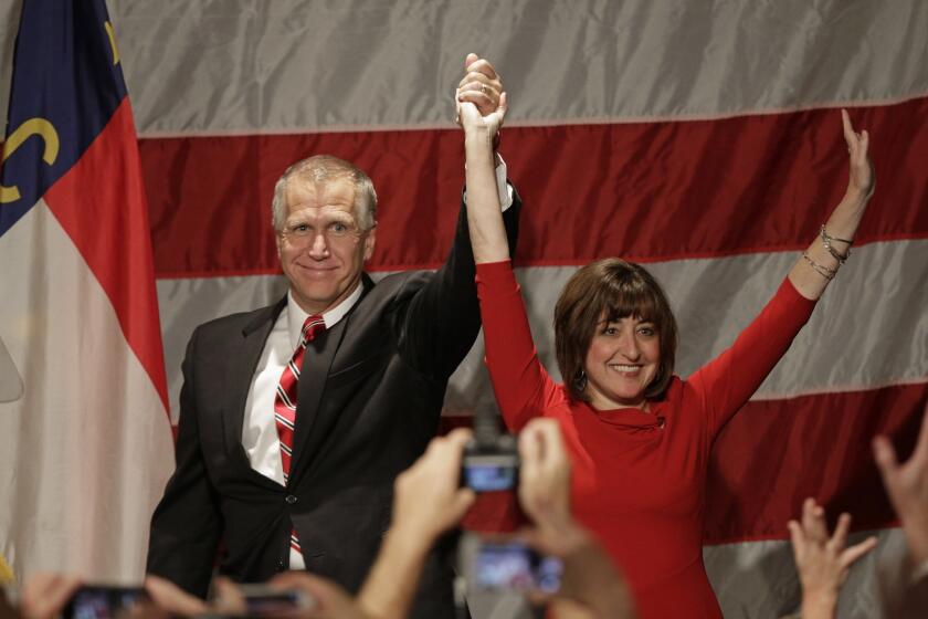 North Carolina House Speaker Thom Tillis, left, and his wife, Susan, celebrate with supporters at a rally in Charlotte, N.C.