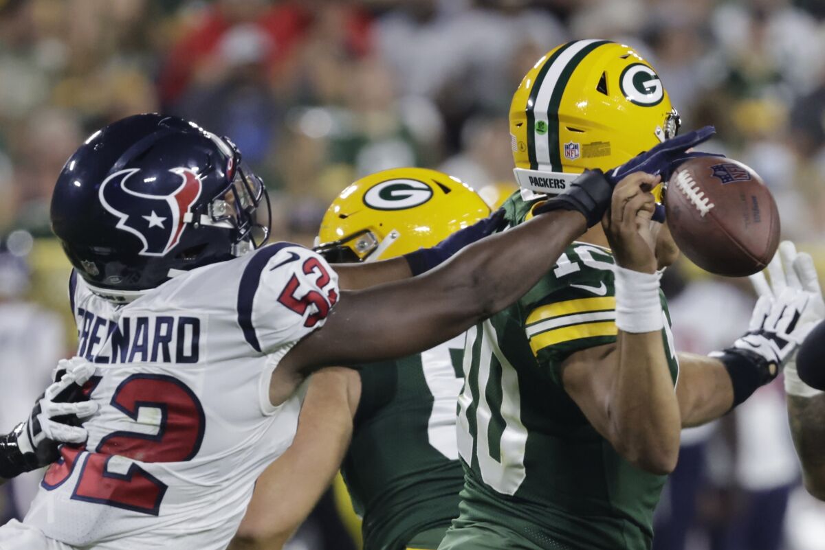 Houston Texans' Jonathan Greenard causes a fumble by Green Bay Packers' Jordan Love during the first half of a preseason NFL football game Saturday, Aug. 14, 2021, in Green Bay, Wis. (AP Photo/Mike Roemer)