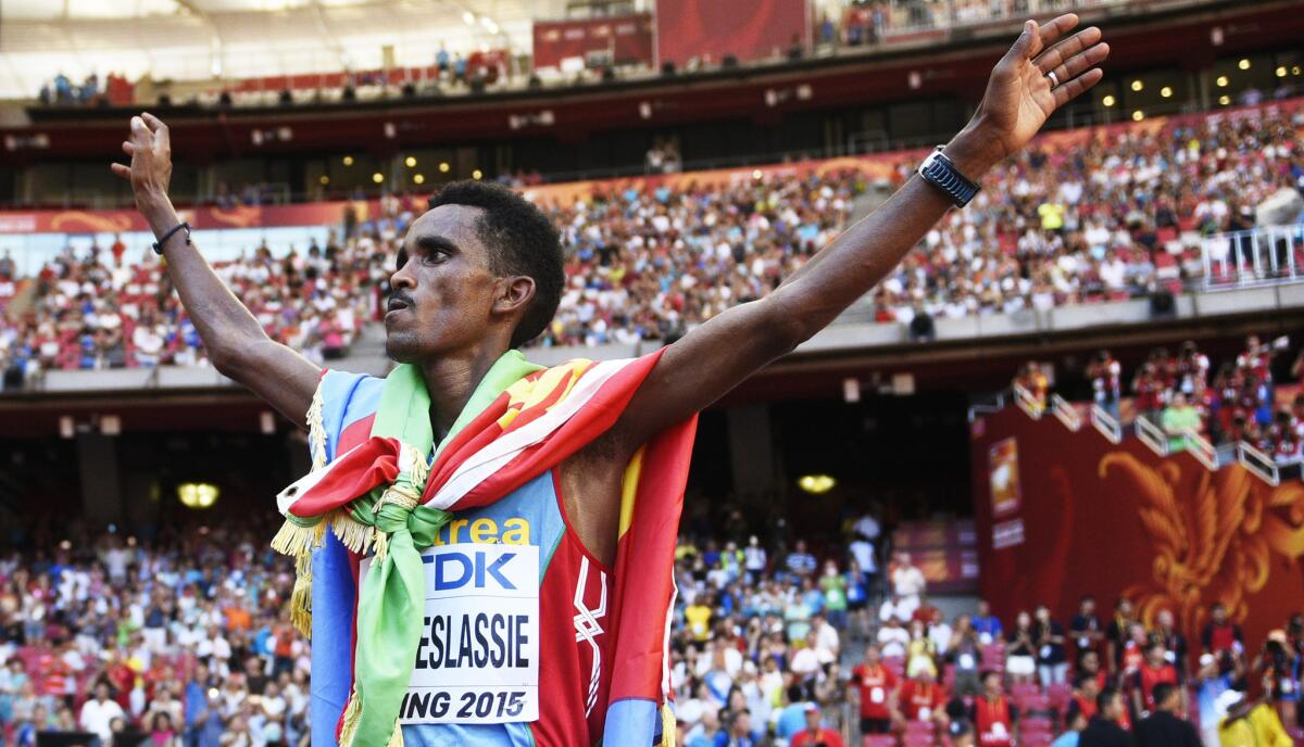 Ghirmay Ghebreslassie of Eritrea celebrates after winning the men's marathon world track and field championships in Beijing.