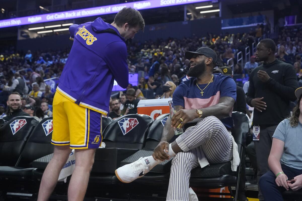 Lakers guard Austin Reaves, left, talks with LeBron James during the first half Friday.
