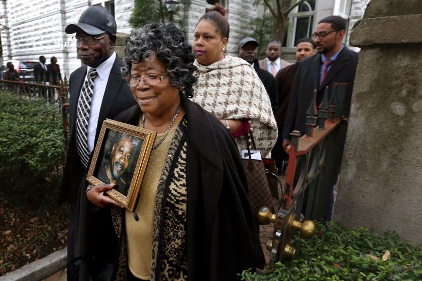 The parents of Walter Scott, Walter Scott Sr. and Judy Scott, leave the courthouse after former North Charleston police officer Michael Slager was sentenced to 20 years in prison for the 2015 shooting death of their son, Thursday, Dec. 7, 2017, in Charleston, S.C. (Grace Beahm Alford/The Post And Courier via AP)