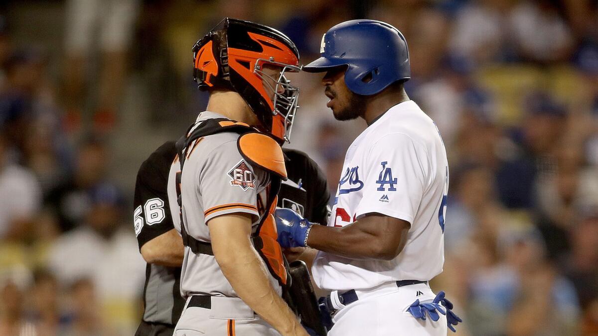 Dodgers hitter Yasiel Puig shoves Giants catcher Nick Hundley at the plate in the bottom of the seventh inning Aug. 14 at Dodger Stadium.