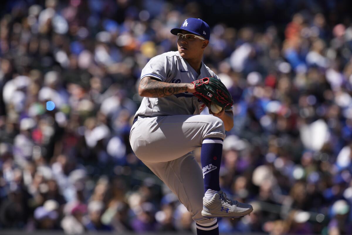 Dodgers pitcher Julio Urías delivers in the first inning of a 9-4 loss to the Colorado Rockies on Sunday.