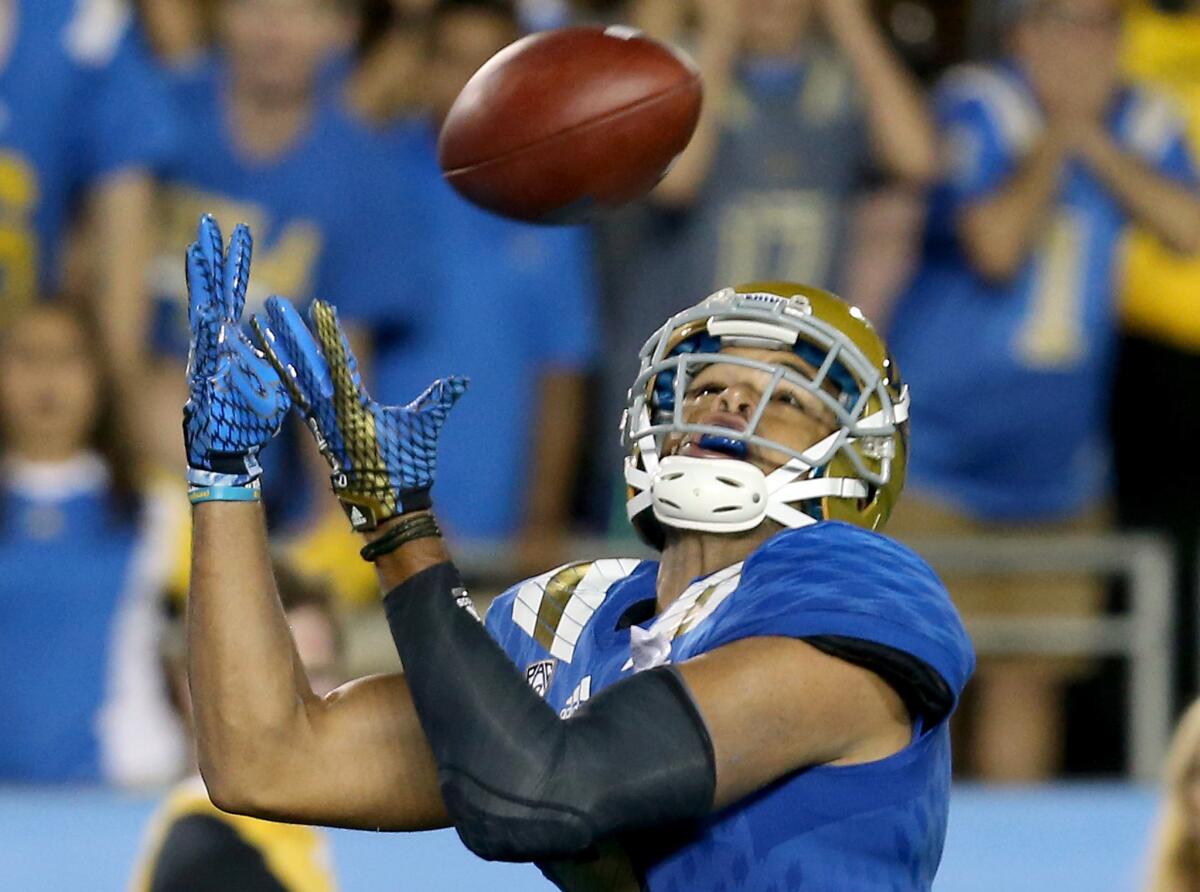 UCLA receiver Jordan Payton makes a touchdown catch against BYU in the fourth quarter Saturday at the Rose Bowl.