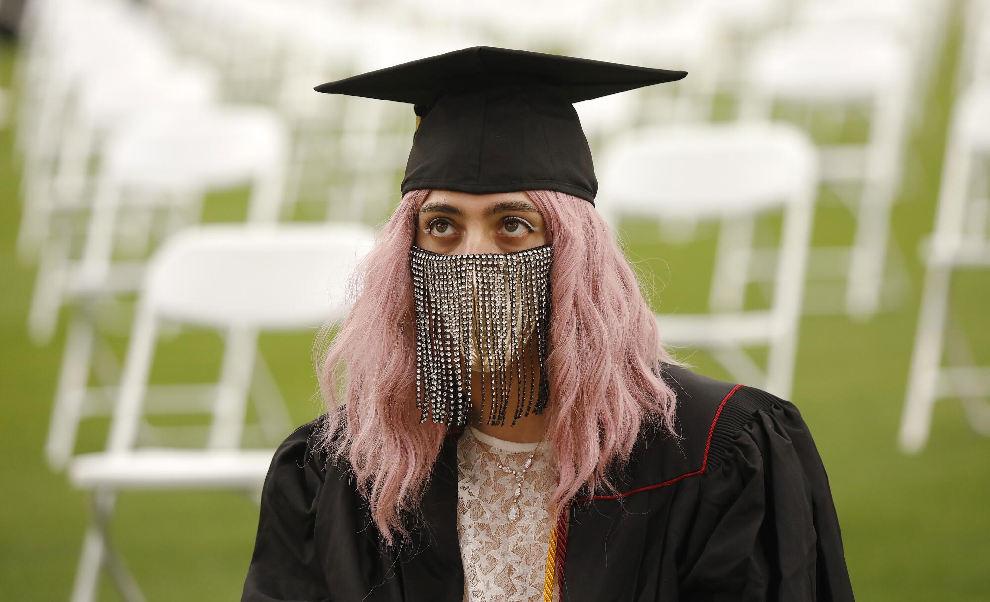  Ecstasy Plant is graduating with a BA in art wears a unique mask.