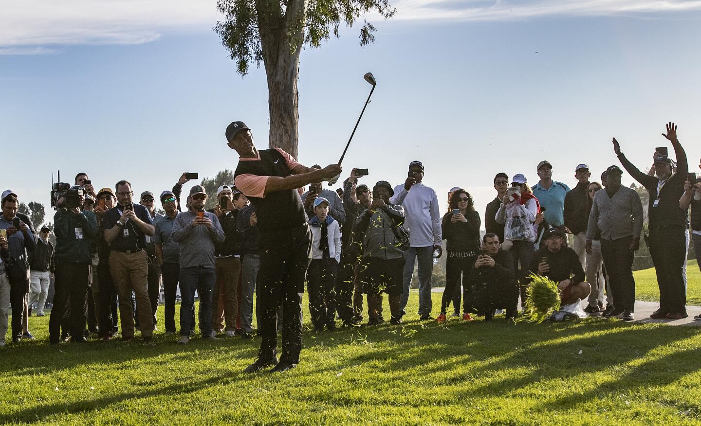 Tiger Woods as he hits out of the rough on the 18th hole during the first round of the Genesis Invitational at Riviera Country Club on Feb. 13, 2020.