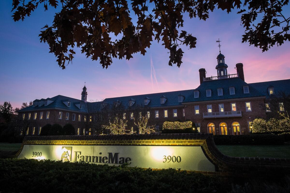 The sun sets behind the Fannie Mae headquarters in Washington, D.C., in 2013. On Monday, Fannie Mae and Freddie Mac announced details of programs to back mortgages with down payments as low as 3%.