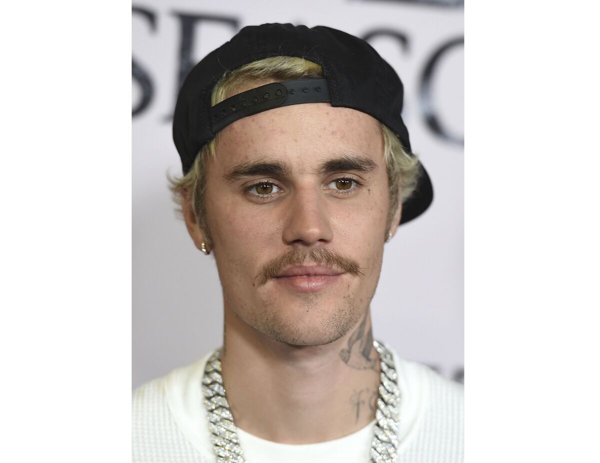 FILE - In this Jan. 27, 2020, file photo, Justin Bieber arrives at the Los Angeles premiere of "Justin Bieber: Seasons." Justin Bieber leads this year’s list of nominees at the 2021 MTV Video Music Awards, followed closely by Megan Thee Stallion, Billie Eilish, BTS, Doja Cat, Drake, Giveon, Lil Nas X and first-time nominee Olivia Rodrigo. Bieber has seven nods, including video of the year and best direction for “POPSTAR,” artist of the year, best cinematography for “Holy” and best pop song, best editing and best collaboration for “Peaches.” (Photo by Jordan Strauss/Invision/AP, File)