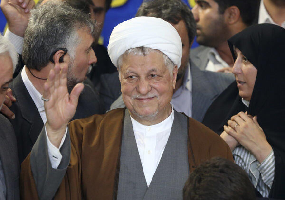 Former Iranian President Akbar Hashemi Rafsanjani waves to media earlier this month as he registers his candidacy for the upcoming presidential election. On Tuesday, Iran's election overseers rejected Rafsanjani and another powerful figure from running.