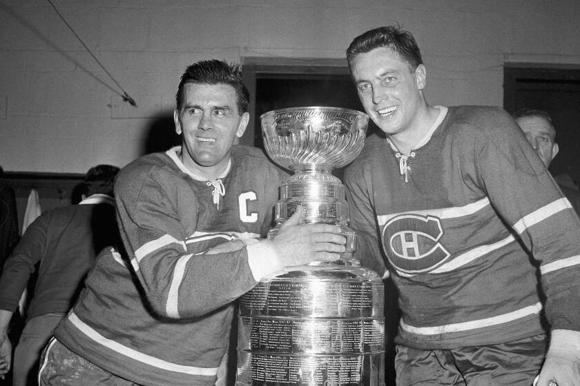 Maurice Richard, left, and Jean Beliveau, celebrate after the Montreal Canadiens' Stanley Cup victory over the Boston Bruins in 1958.