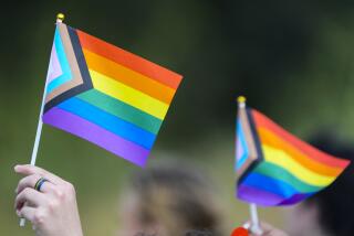KATY, TEXAS - AUGUST 30: Students hold flags as they protest against Katy ISD's new transgender policy outside the school district's educational support complex on Wednesday, Aug. 30, 2023 in Katy. (Brett Coomer/Houston Chronicle via Getty Images)