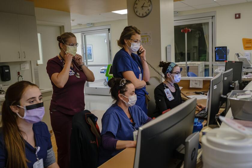 SAN DIEGO, CALIF. -- FRIDAY, APRIL 10, 2020: Nurses oversee the Emergency Department patients details on monitors as they treat patients who have been brought in with possible COVID-19 symptoms at Sharp Memorial Hospital in San Diego, Calif., on April 10, 2020. As of Friday afternoon, there have been1,693 cases and 44 deathsamong San Diego County residents. Across California there have been19,472 cases and 541 deaths. (Marcus Yam / Los Angeles Times)