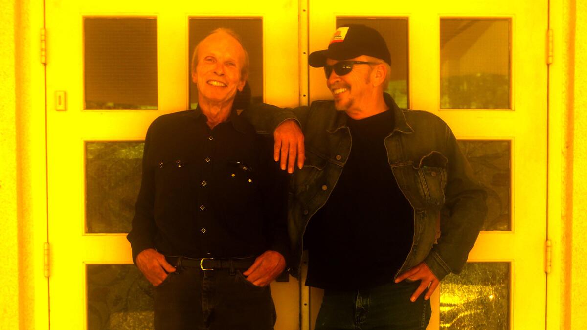 Siblings Phil, left, and Dave Alvin in downtown Downey on Aug. 31, 2015. The brothers' new album, "Lost Time," further explores the blues and R&B influences that inspired the Downey residents as kids before they grew up and formed the roots-rock band the Blasters.