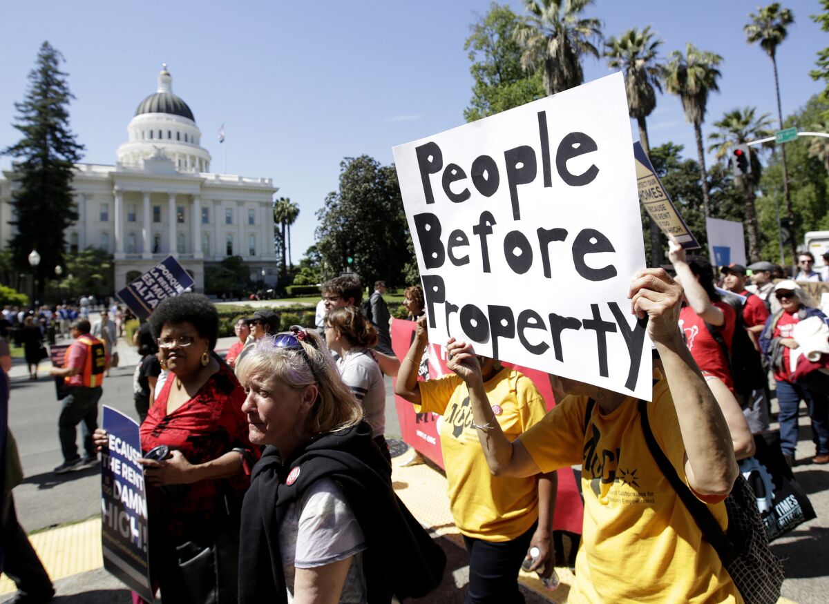 Supporters of a rent control initiative march near the Capitol in Sacramento in April 2018.