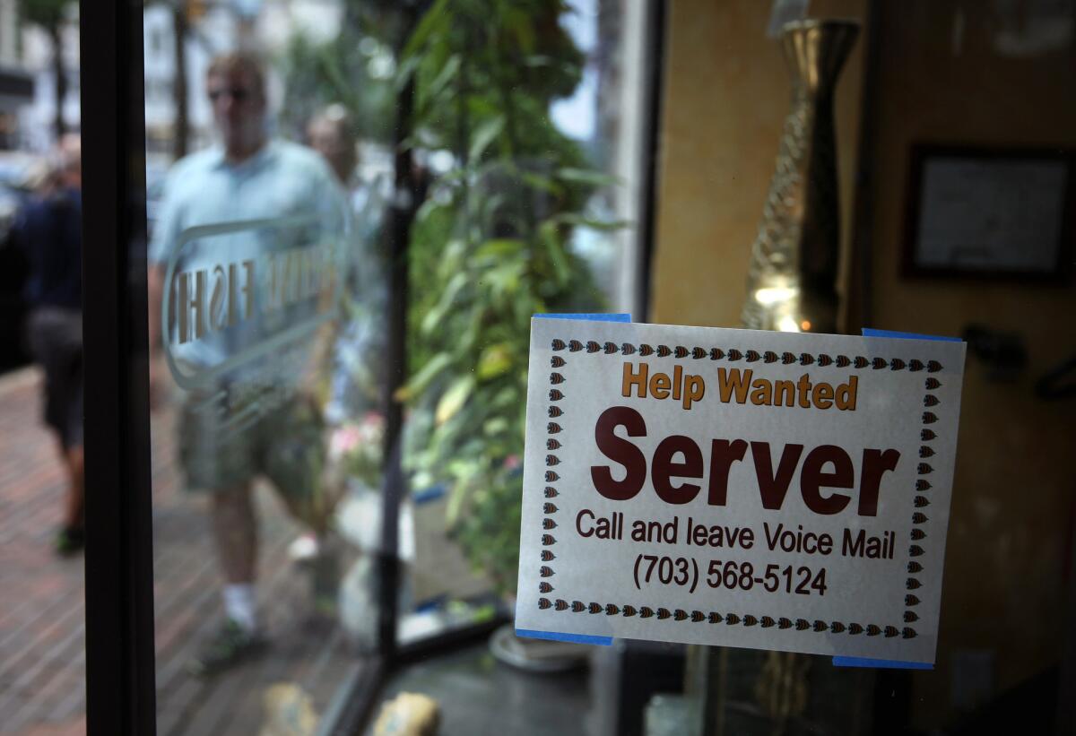 A hiring sign at a restaurant Friday in Alexandria, Va. The Labor Department reported that the U.S. economy added 195,000 jobs in June, with the unemployment rate remained unchanged at 7.6%.