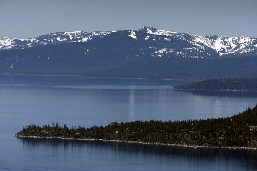 A view of snow-capped mountains, Lake Tahoe, and the historic Cal-Neva Resort & Casino.