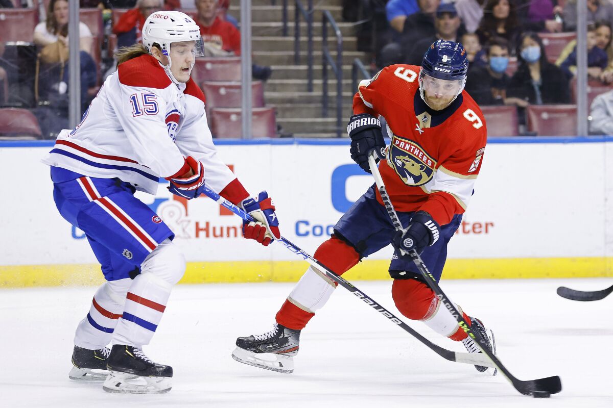 Florida Panthers center Sam Bennett (9) takes a shot on goal against the Montreal Canadiens during the first period of an NHL hockey game, Saturday, Jan. 1, 2022, in Sunrise, Fla. (AP Photo/Michael Reaves)