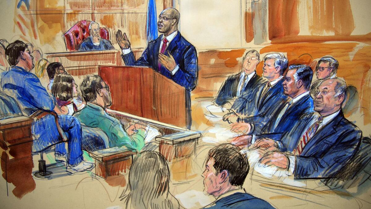Assistant U.S. Atty. Uzo Asonye, standing, makes his opening arguments in the case against Paul Manafort, seated second from right in the front row in this courtroom sketch.