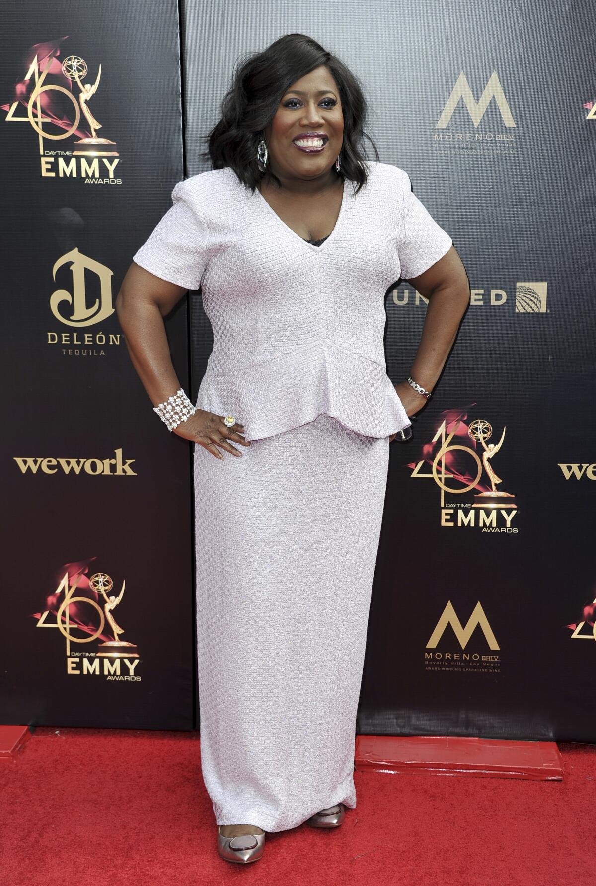 Sheryl Underwood in a formal white dress