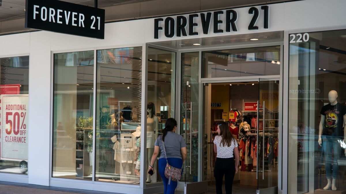 Shoppers enter the Forever 21 store at the Santa Monica Place mall on Thursday. Many young consumers are migrating to other retailers, especially online sellers.