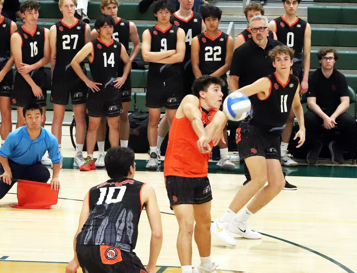 Huntington Beach's Aiden Atencio (1) receives a serve against Mira Costa on Saturday.