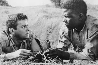 Tony Curtis, Rt, and Sidney Poitier in the movie “The Defiant Ones.”