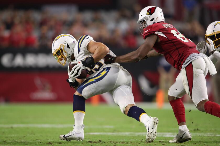 GLENDALE, ARIZONA - AUGUST 08: Linebacker Drue Tranquill #49 of the Los Angeles Chargers intercepts a pass ahead of tight end Darrell Daniels #81 of the Arizona Cardinals during the NFL preseason game at State Farm Stadium on August 08, 2019 in Glendale, Arizona. The Cardinals defeated the Chargers 17-13. (Photo by Christian Petersen/Getty Images)