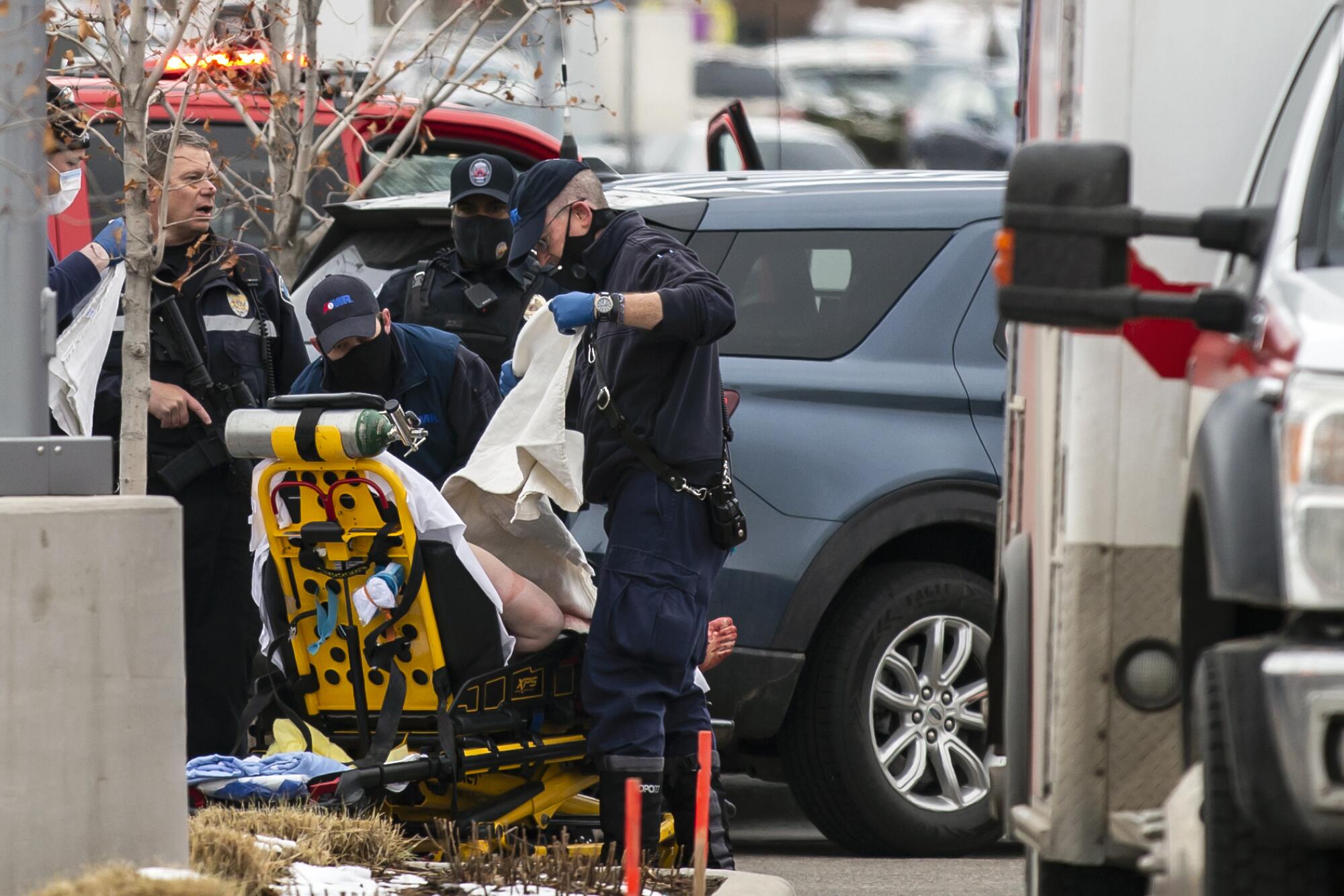 A person is loaded onto a stretcher after a gunman opened fire at a King Sooper's Grocery store on March 22, 2021 in Boulder