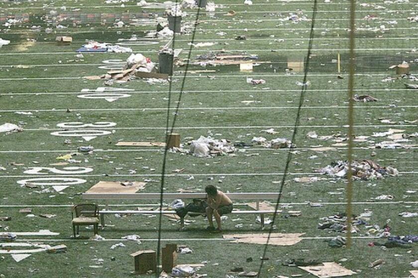EVACUEE: During post-storm flooding, the Superdome housed more than 30,000 people. Several days passed before busses arrived to evacuate them, mainly to Houston.