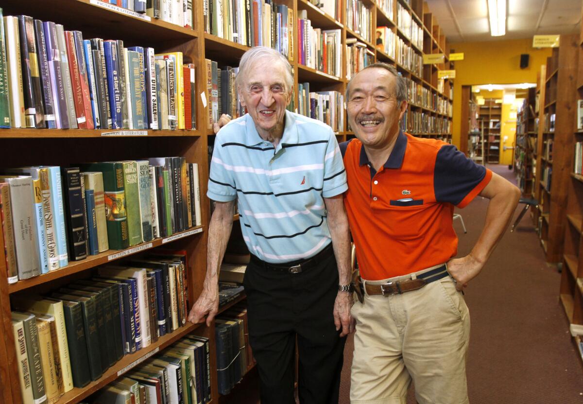 Jerome Joseph, left, and Noriaki Nakano, right, owners of the Brand Bookshop at their N. Brand Blvd. store in Glendale on Thursday, Aug. 28, 2014. The store will close next month after 29 years in business.