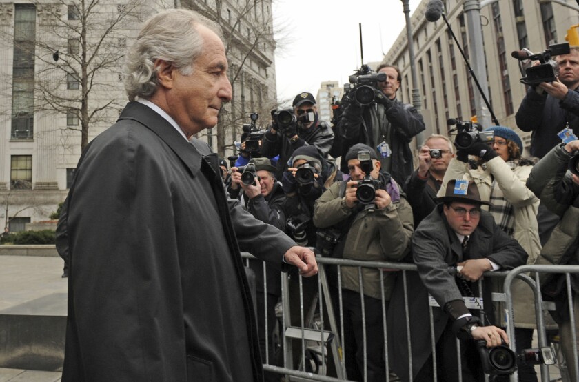 FILE - Bernard Madoff exits Manhattan federal court, Tuesday, March 10, 2009, in New York. The epic Ponzi scheme mastermind is dead. But the effort to untangle his web of deceit lives on. More than 12 years after Madoff confessed to running the biggest financial fraud in Wall Street history, a team of lawyers is still at work on a sprawling effort to recover money for the thousands of victims of his scam.(AP Photo/ Louis Lanzano, File)