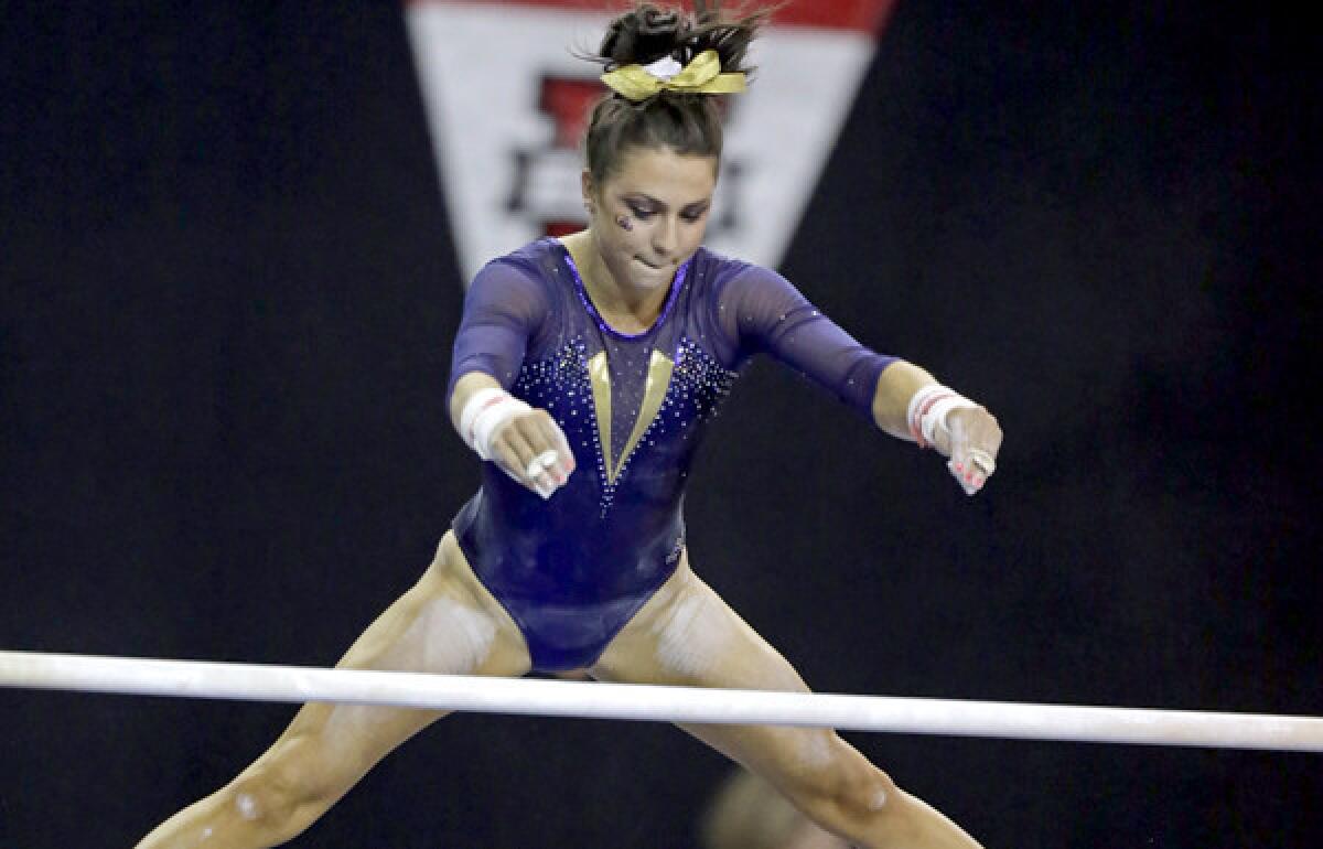 Louisiana State's Rheagan Courville competes in the unevenl bars in the NCAA women's gymnastics championships at Pauley Pavilion.